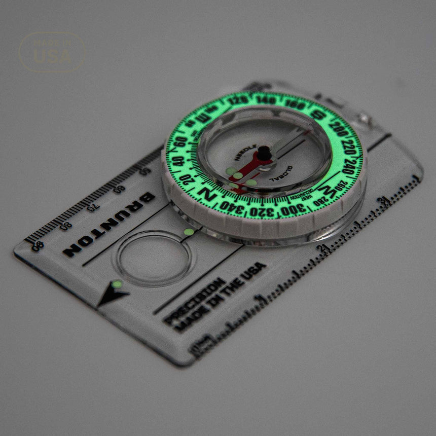 Compass with green glow on a white background