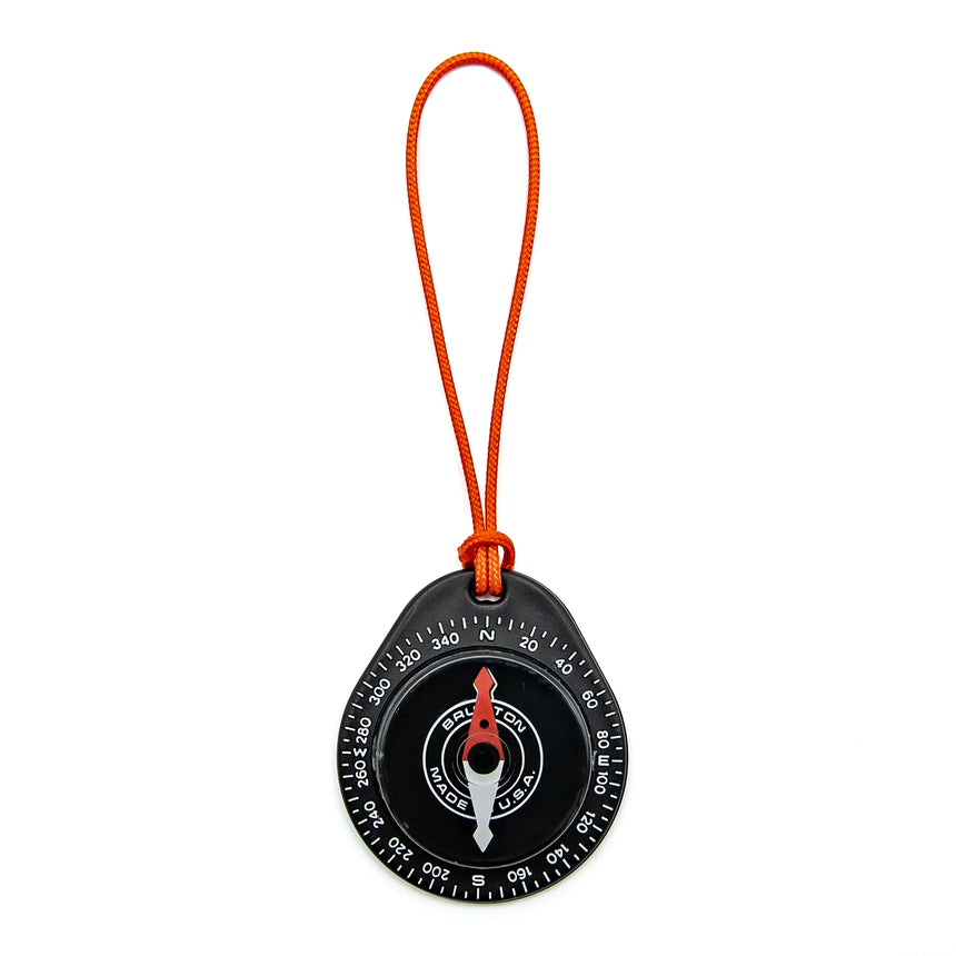 Compass with orange strap on a white background