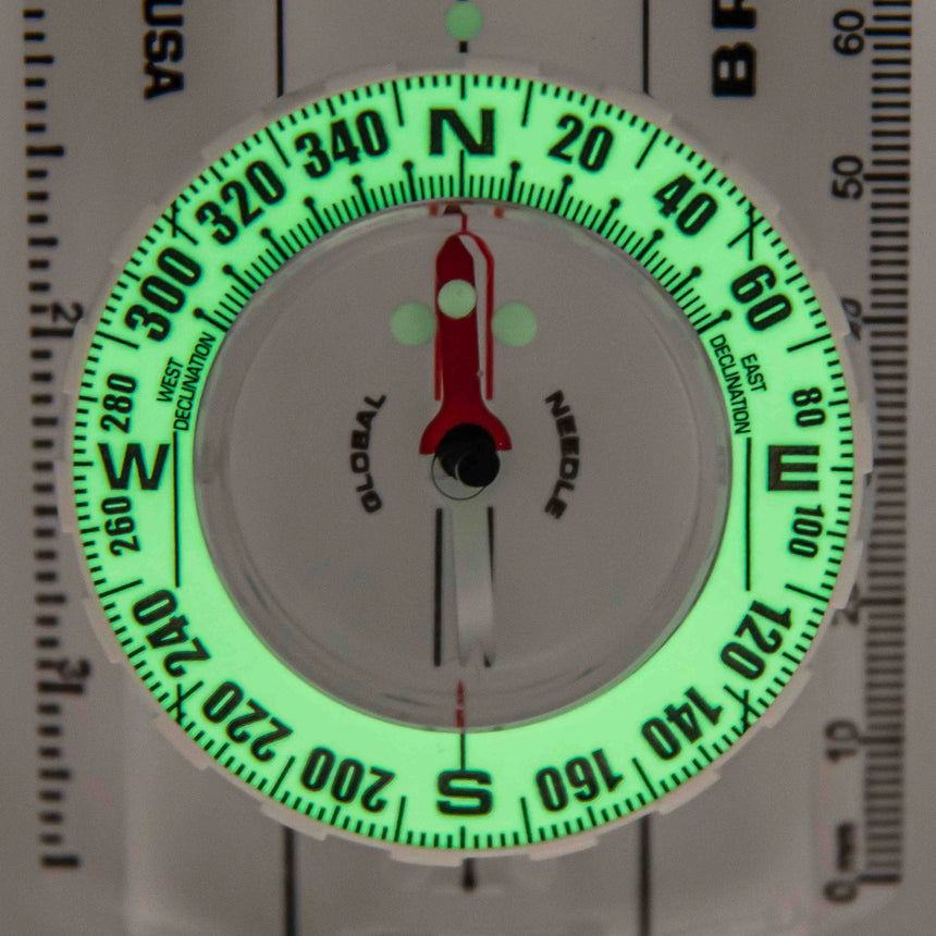 Glow-in-the-dark compass with needle on a white background