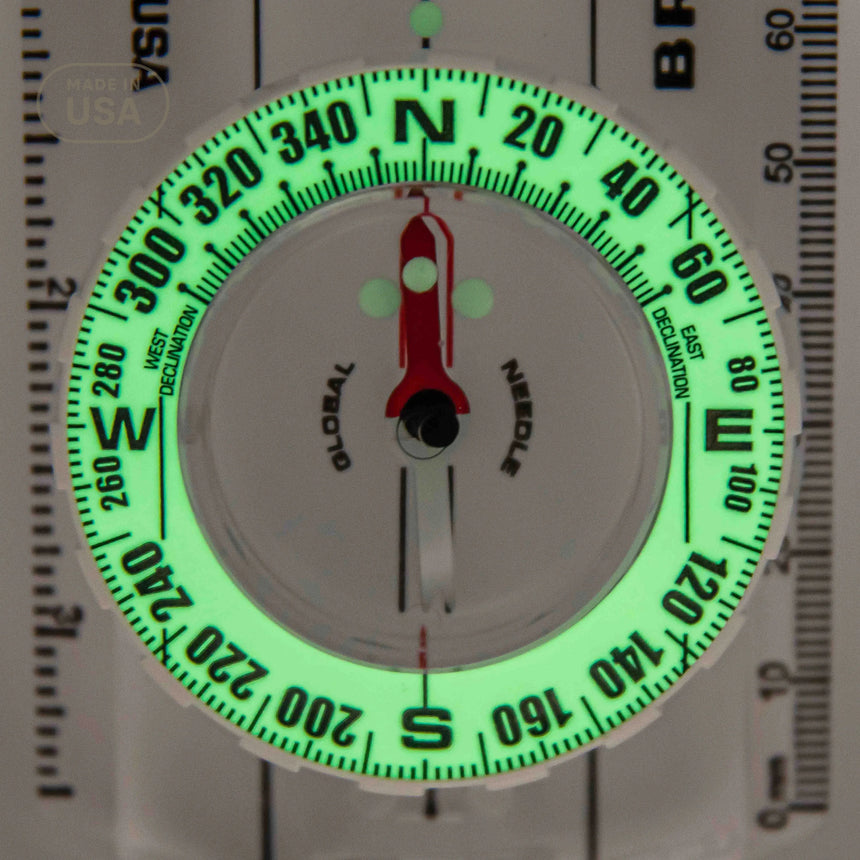Glow-in-the-dark compass with needle on a white background