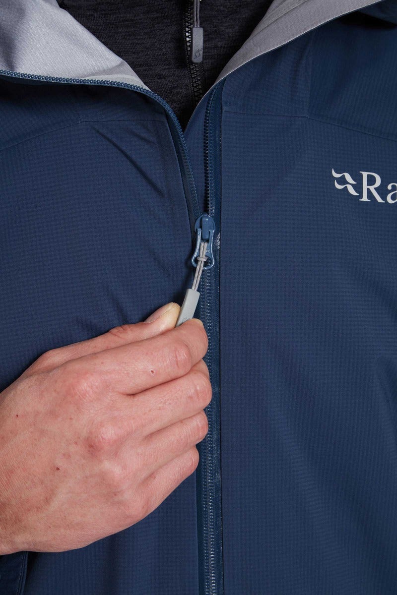 Rab Men's Firewall Light Waterproof Jacket in Tempest Blue - zip pull detail, worn (reference only, not a stocked colour)