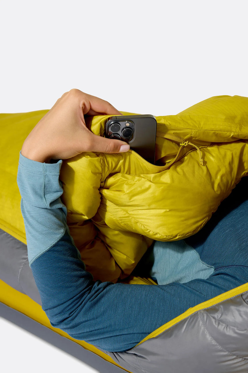 Rab Women's Neutrino Down Sleeping Bag (-6°C/20F) in Zinc/Dark Pollen - Model In Use Side
