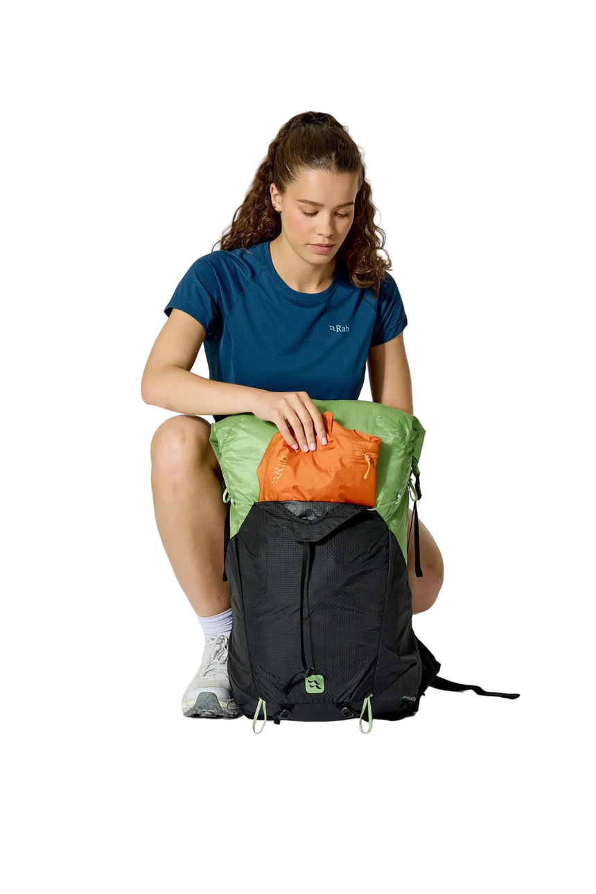 Rab Women's Syclon XP ND 38L Waterproof Pack in Black/Dark Fig Green - Seated View On Model