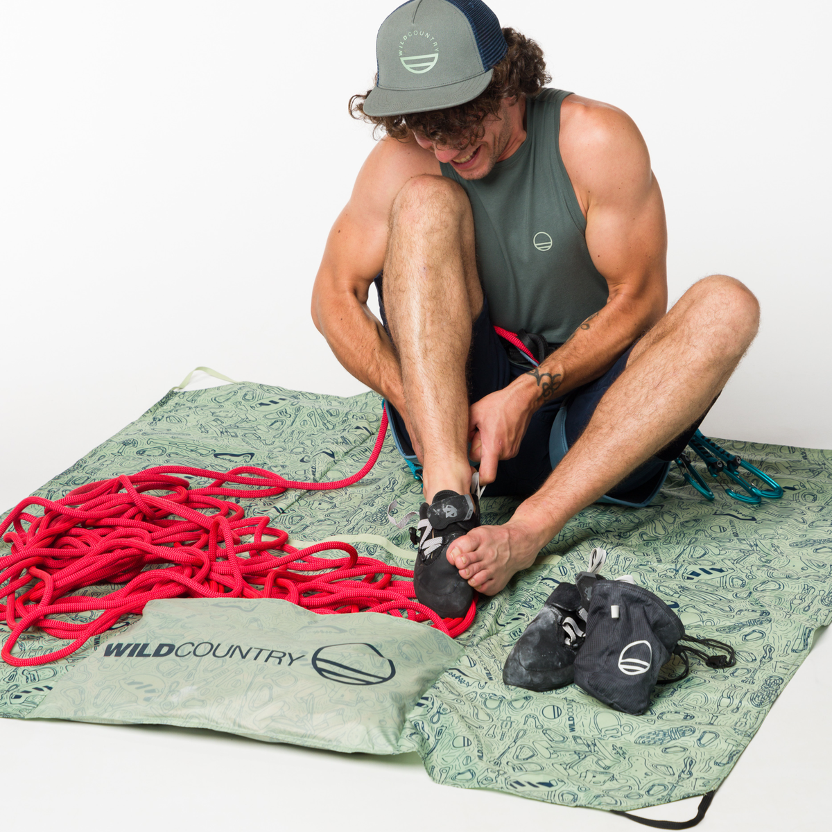 Wild Country Climbing Rope Tarp Model Sitting on Tarp With Rope Attached