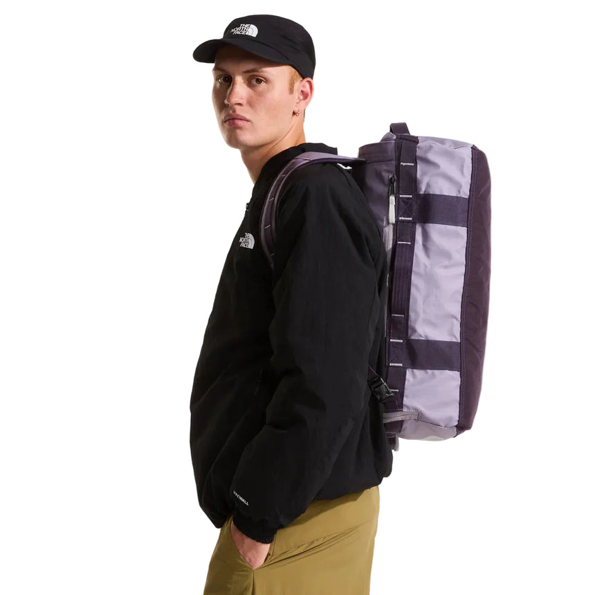 The North Face Base Camp Voyager Duffel 32L Transcendent Grey/Endless Dusk - side view with detachable padded shoulder straps and grab handles