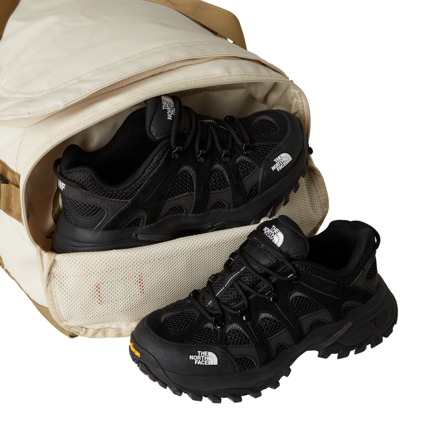 The North Face Base Camp Voyager Duffel 42L Desert Stone/Cedar/Desert Rust - lifestyle shot showing versatile backpack and duffel carry options with 42 litre capacity