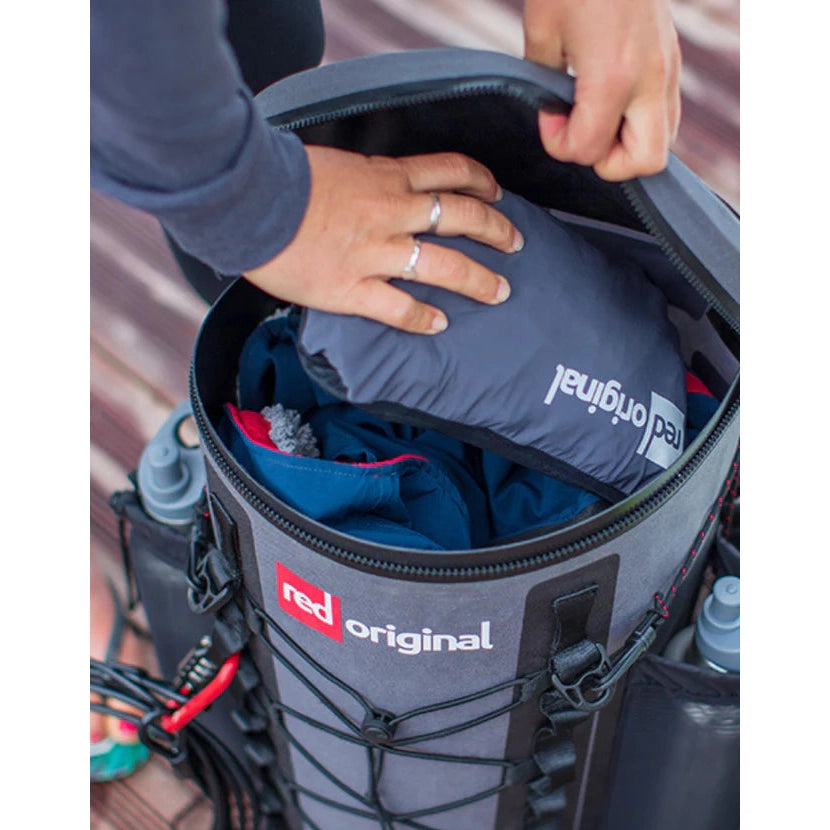 Red Paddle 22L Waterproof SUP Deck Bag - Model Putting Items into Main Compartment