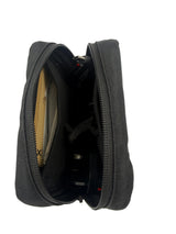 Black zippered pouch with items inside