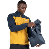 Mountain Equipment Lightline Men's Vest in Blue Nights packed into internal pocket on model showing lightweight packable construction