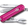 Pink Victorinox Swiss Army knife open on a white background