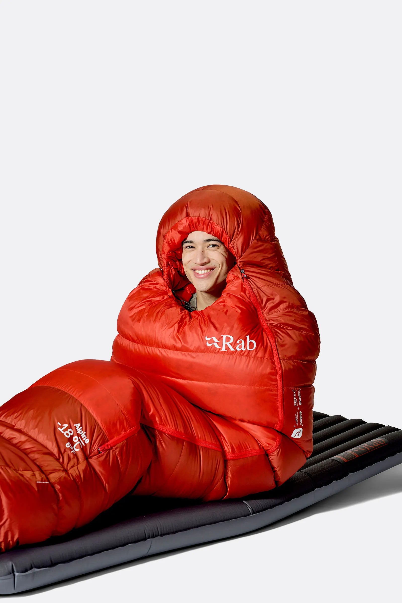 Rab Alpine Down Sleeping Bag (0°C/32F) in Dark Horizon/Tuscan Red - worn, sitting up
