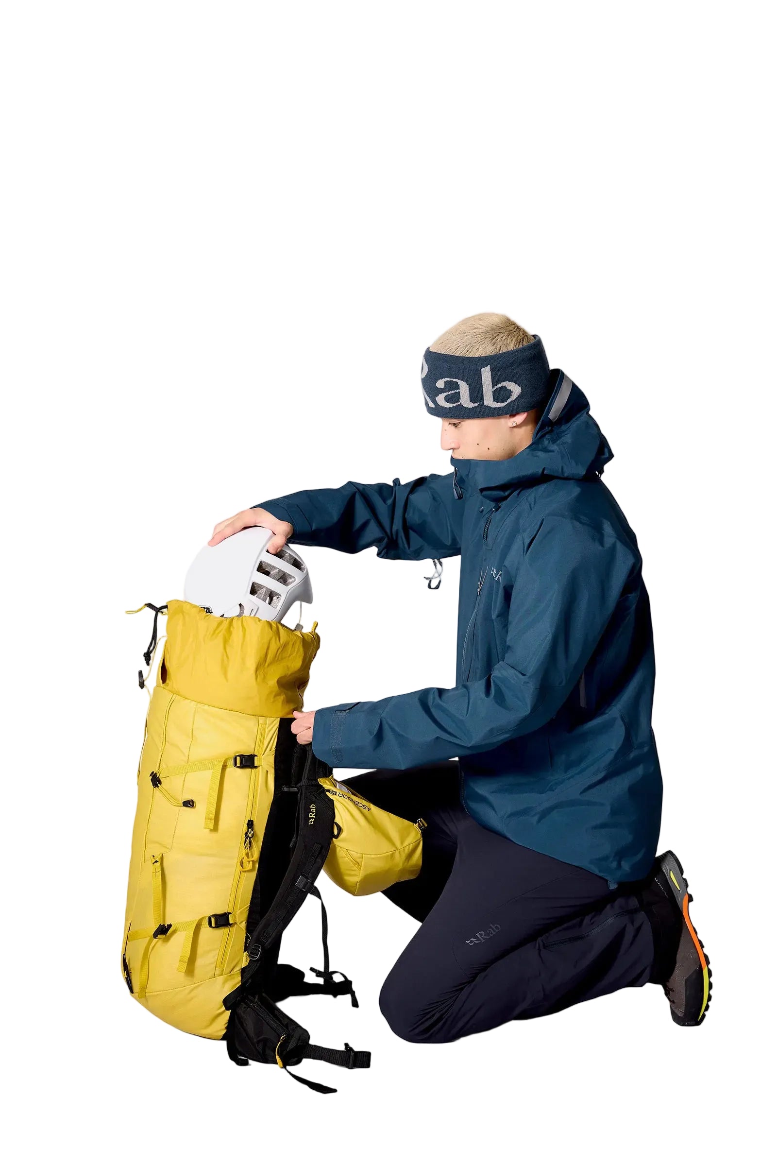 Rab Ascendor 45L Mountain Pack in Dark Pollen - Model Kneeling Side View