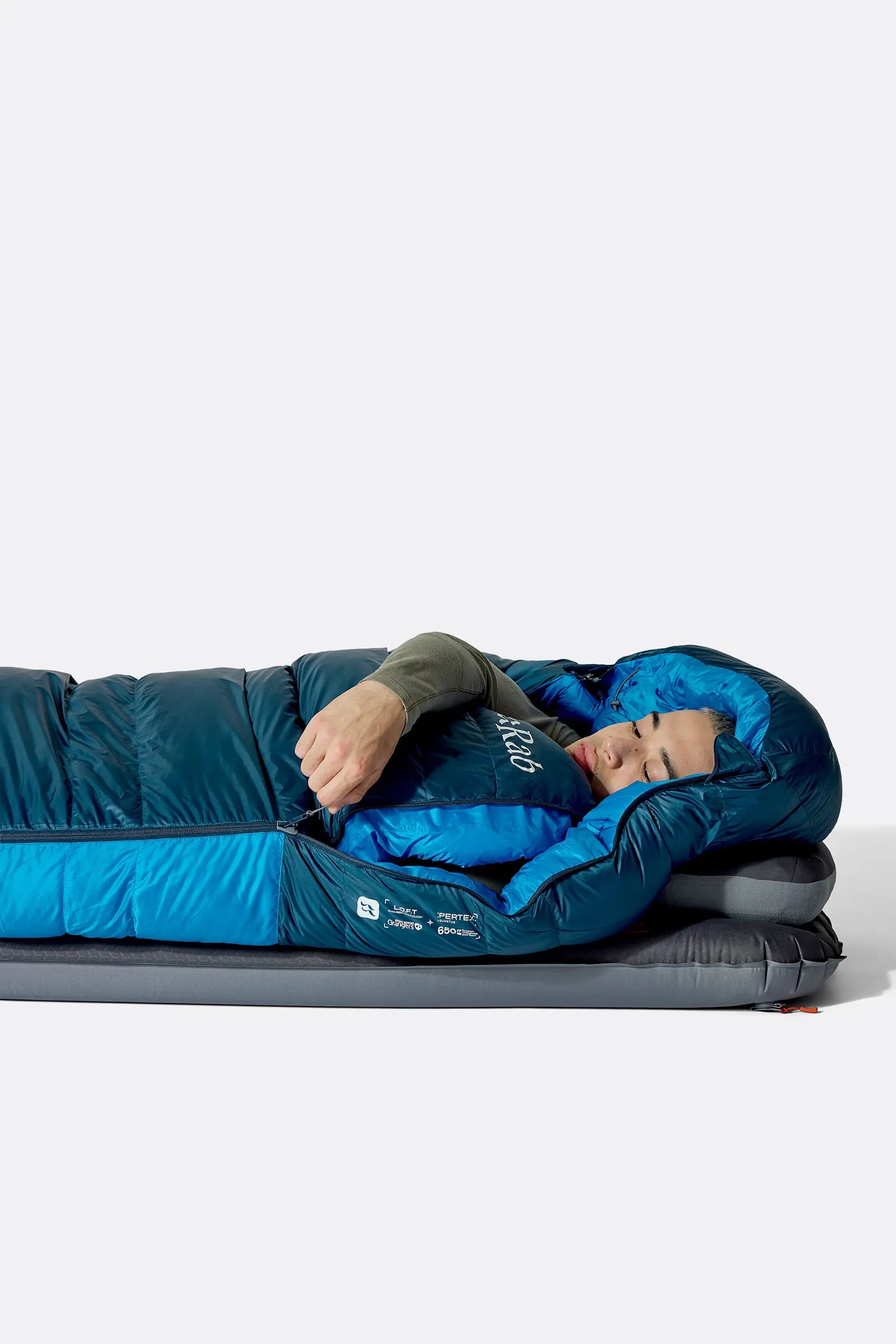 Rab Ascent Down Sleeping Bag (0°C/32F) in Tempest Blue/Maya Blue - Model Lying Wrapped