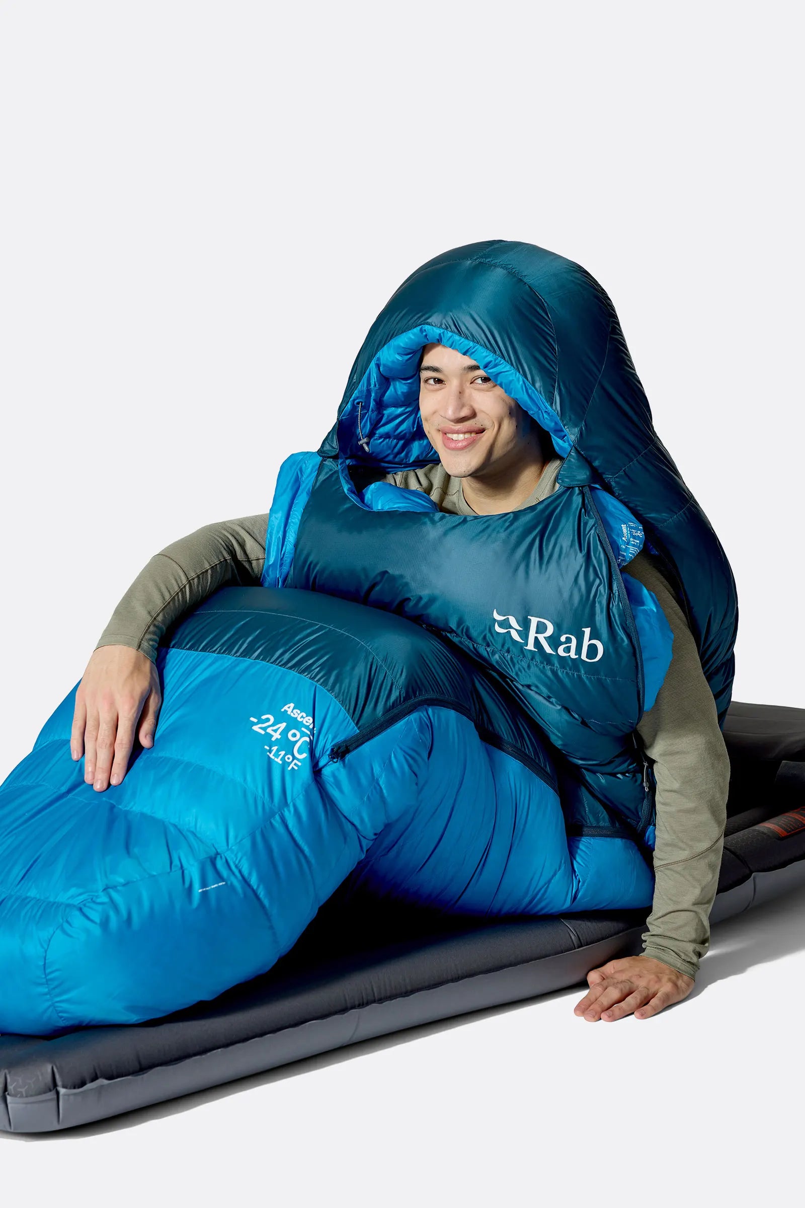Rab Ascent Down Sleeping Bag (0°C/32F) in Tempest Blue/Maya Blue - Model Seated