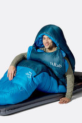 Rab Ascent Down Sleeping Bag (-18°C/0F) in Tempest Blue/Maya Blue - Model Seated