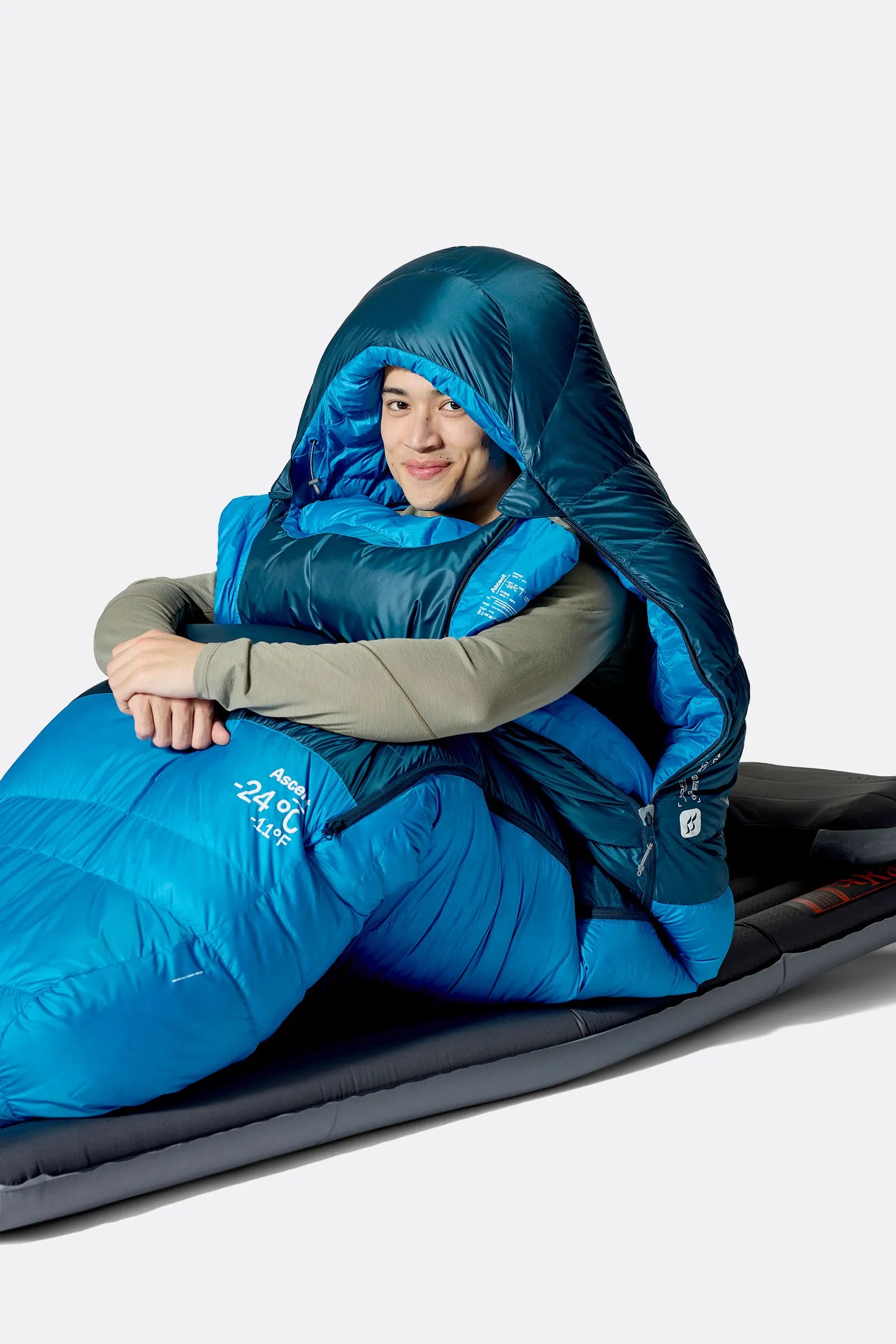 Rab Ascent Down Sleeping Bag (-6°C/21F) in Tempest Blue/Maya Blue - Model Seated Hood