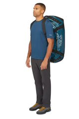 Rab Expedition II 120L Kitbag in Blue - Model Carrying Over Shoulder
