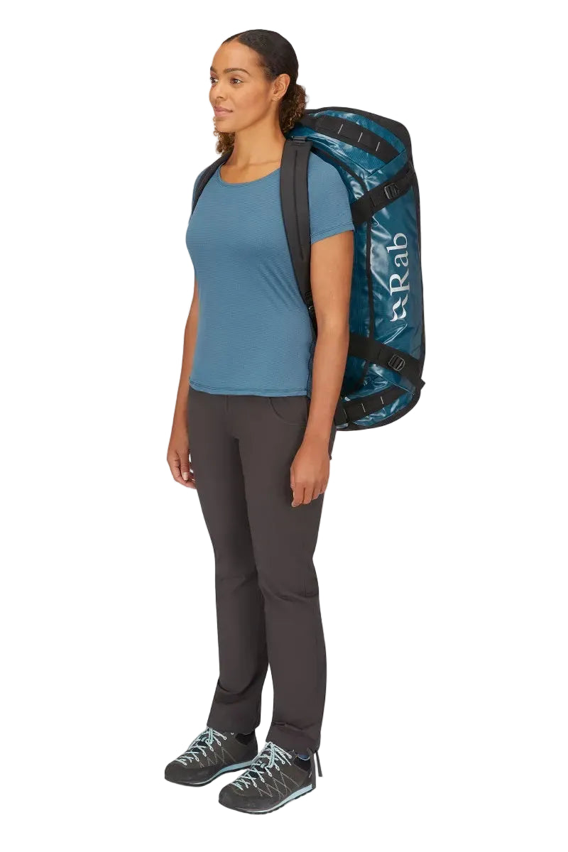 Rab Expedition II 80L Kitbag in Blue - Model Carrying as Duffel Three Quarter View