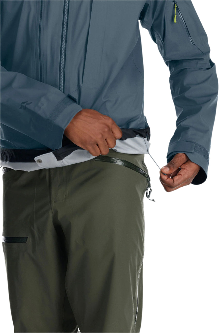 Rab Men's Khroma Kinetic Waterproof Ski Jacket in Orion Blue - pocket detail, worn
