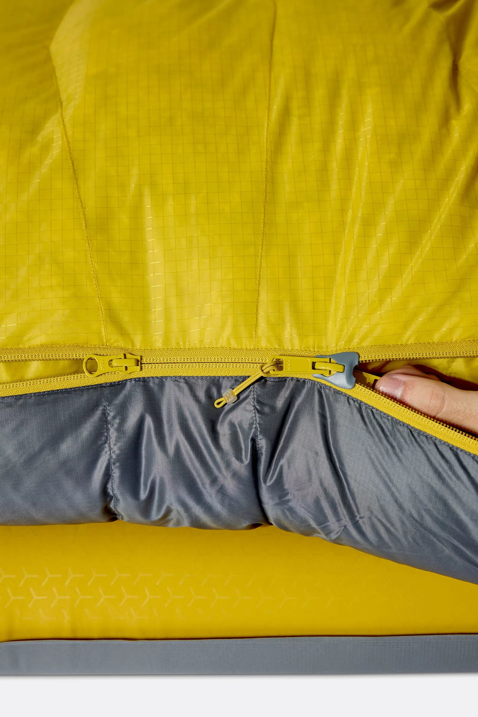 Rab Neutrino Down Sleeping Bag (-6°C/20F) in Graphene/Dark Pollen - Model Sitting Up
