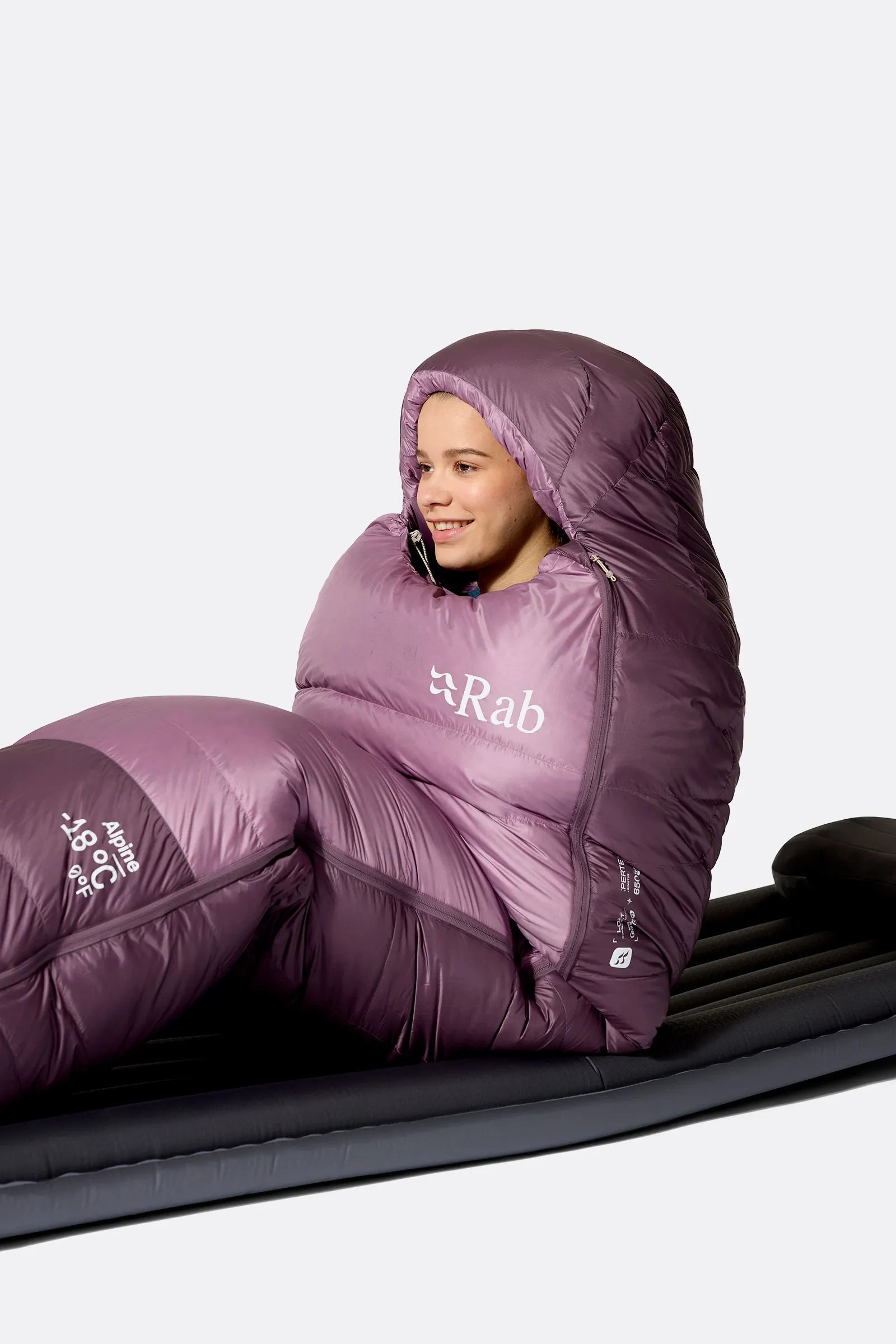 Rab Women's Alpine Down Sleeping Bag (-12°C/10F) in Iris/Dark Iris - Model Seated Hood