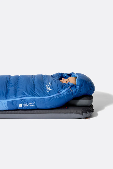 Rab Women's Ascent Down Sleeping Bag (-12°C/10F) in Dark Bluebird/Birdbird - Model Lying Top