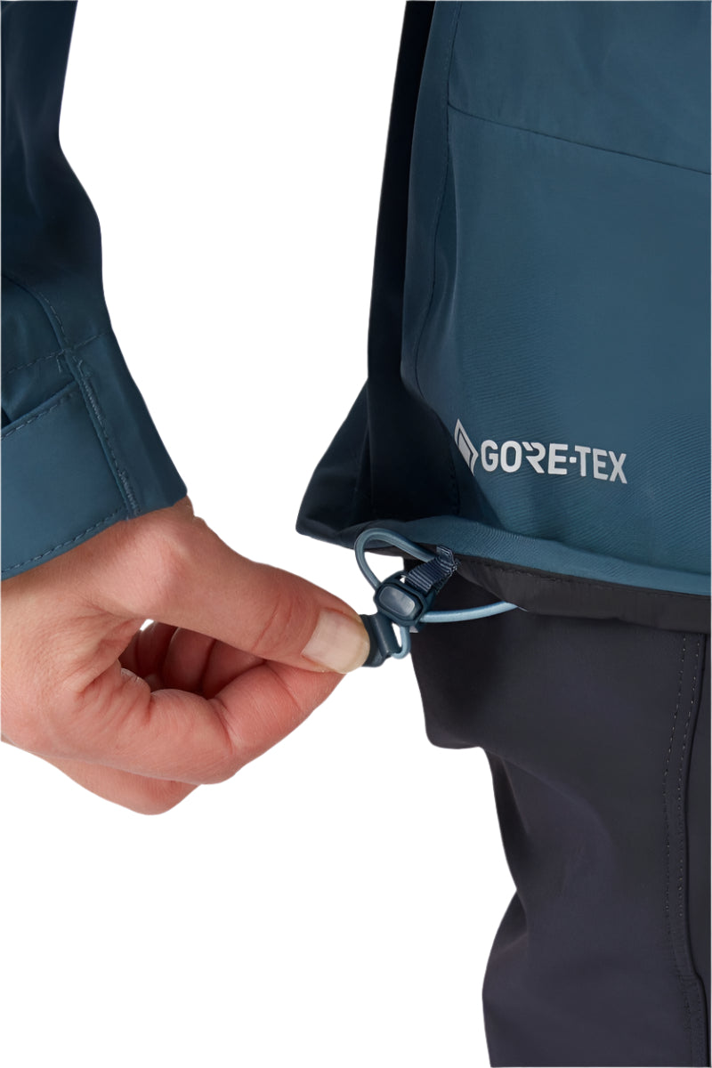 Rab Women's Namche GORE-TEX Jacket in Orion Blue - hem adjustment detail, worn