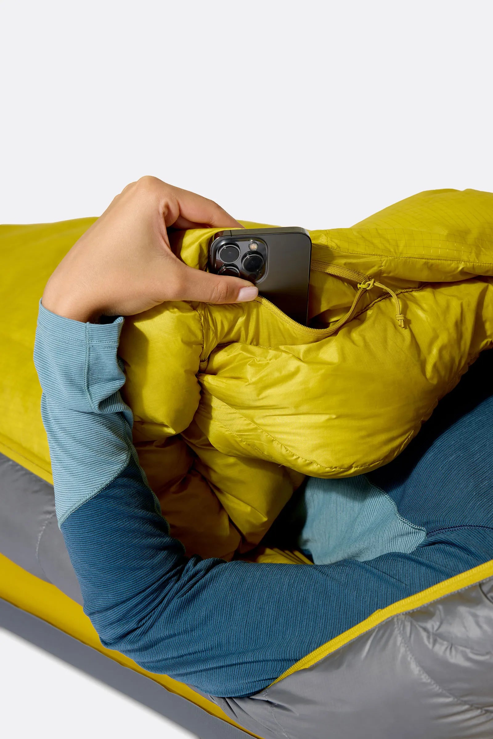 Rab Women's Neutrino Down Sleeping Bag (-6°C/20F) in Zinc/Dark Pollen - Model In Use Side