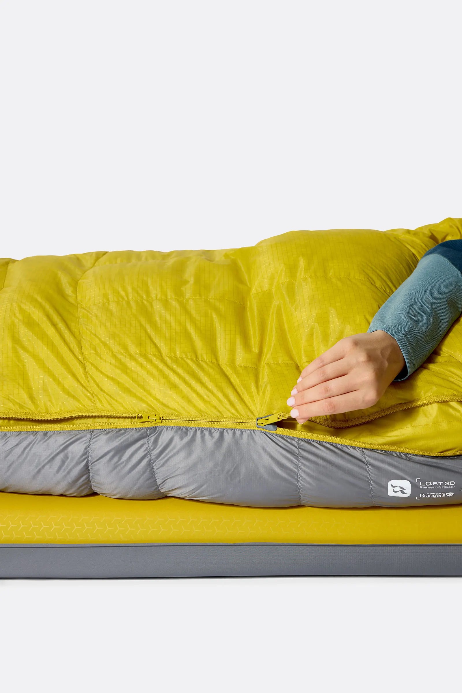Rab Women's Neutrino Down Sleeping Bag (-6°C/20F) in Zinc/Dark Pollen - Model Lying Left