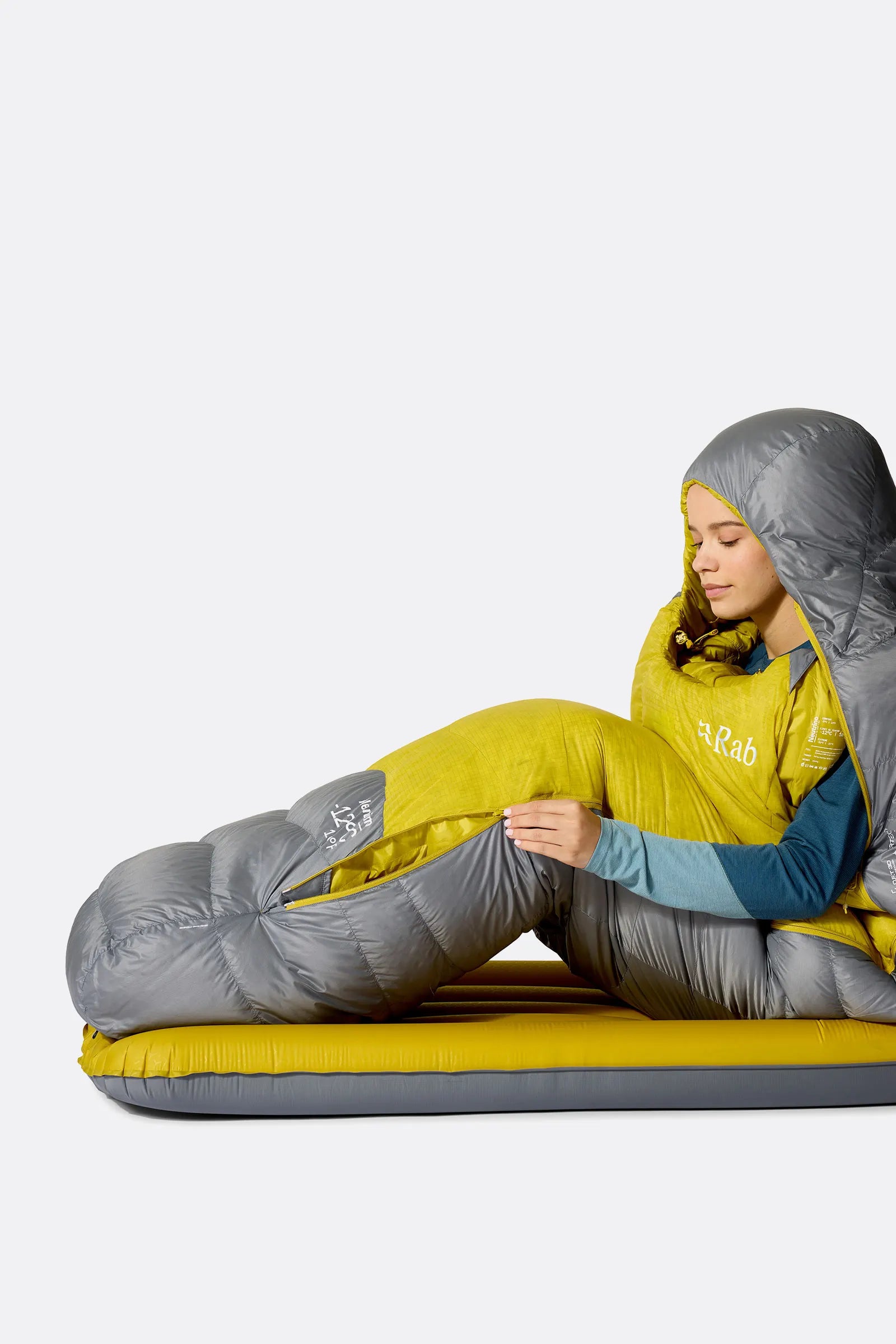 Rab Women's Neutrino Down Sleeping Bag (-6°C/20F) in Zinc/Dark Pollen - Model Seated