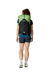 Rab Women's Syclon XP ND 38L Waterproof Pack in Black/Dark Fig Green - Side View On Model 2