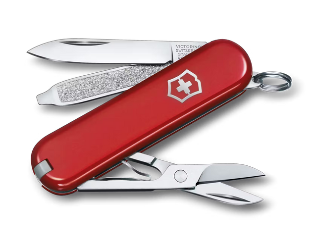 Red Swiss Army knife with open tools on a white background