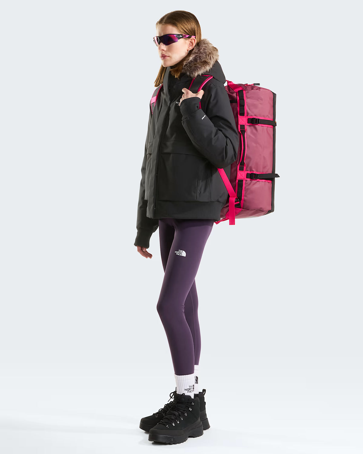 The North Face Base Camp Duffel - Small in Burgundy Crush/TNF Black - worn, side profile