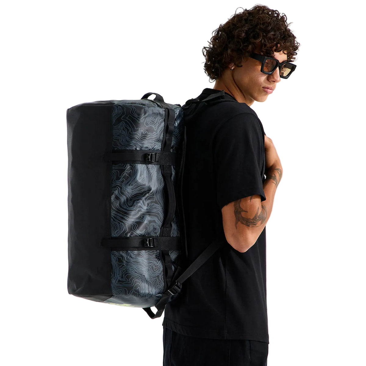 The North Face Base Camp Duffel - Small in TNF Black Glowing Topo Print - worn, back view