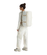 The North Face Base Camp Duffel Small White Ash/Calac - side view with detachable ergonomic shoulder straps and padded handles