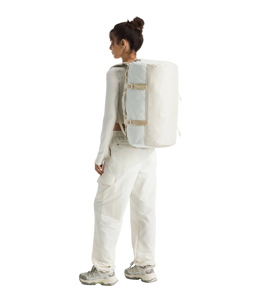 The North Face Base Camp Duffel Small White Ash/Calac - side view with detachable ergonomic shoulder straps and padded handles