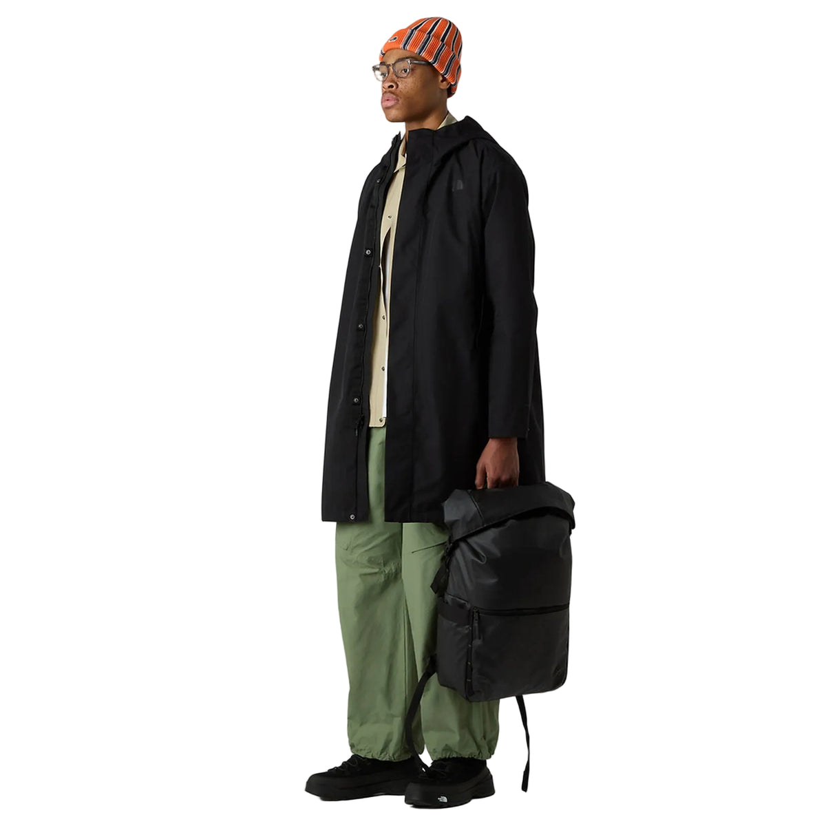 The North Face Base Camp Voyager Roll Top Backpack 25L in use for weekend travel, showing versatile storage capacity