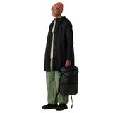 The North Face Base Camp Voyager Roll Top Backpack 25L in use for weekend travel, showing versatile storage capacity