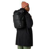 Side view of The North Face Base Camp Voyager Roll Top Backpack displaying water bottle pockets and daisy-chain webbing