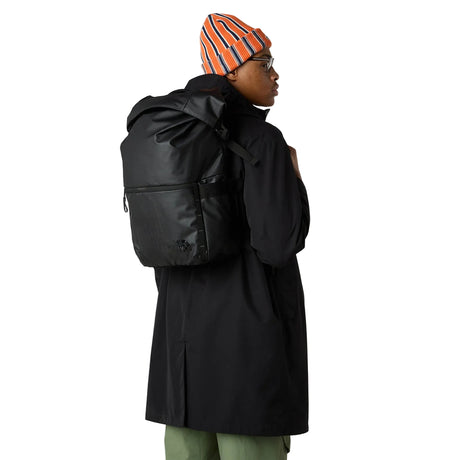 Side view of The North Face Base Camp Voyager Roll Top Backpack displaying water bottle pockets and daisy-chain webbing