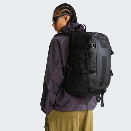 Side view of The North Face Hot Shot Base Camp Backpack displaying water bottle pockets and compression straps