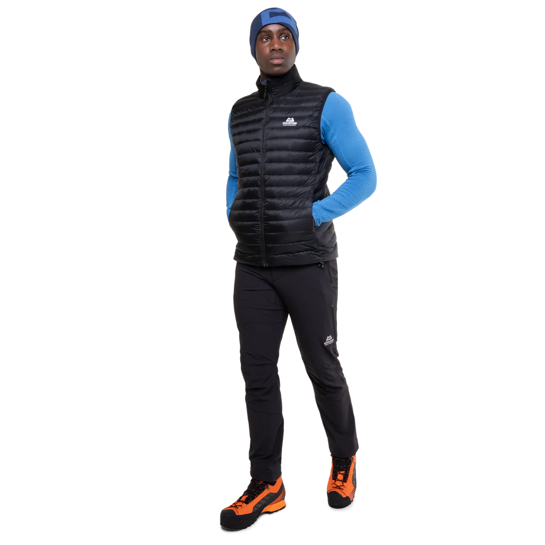 Mountain Equipment Frostline Men's Vest in Black worn on model - full length angled front view showing lightweight packable down vest for year-round layering