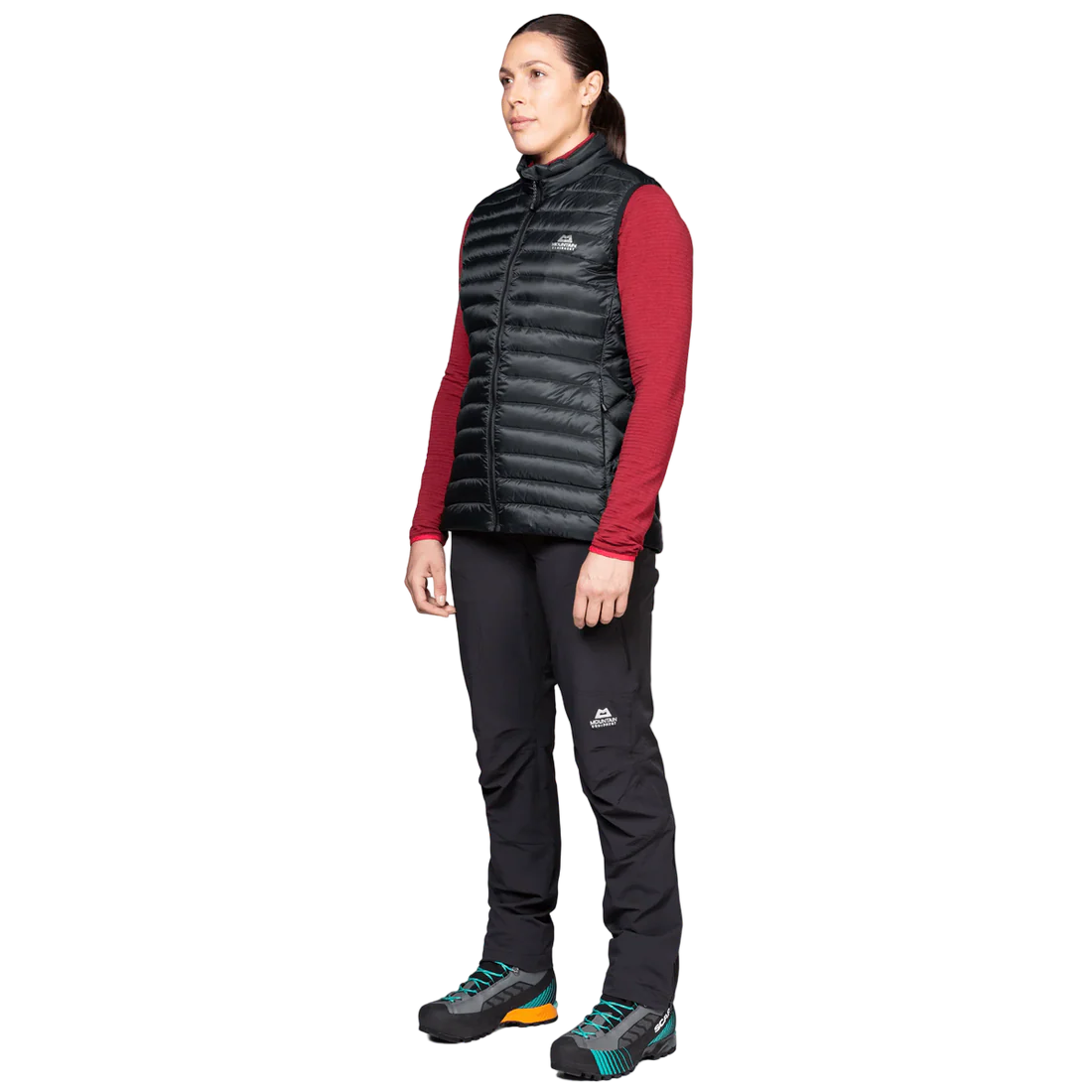 Mountain Equipment Frostline Women's Vest in Black worn on model - angled front view showing lightweight packable down vest for year-round layering