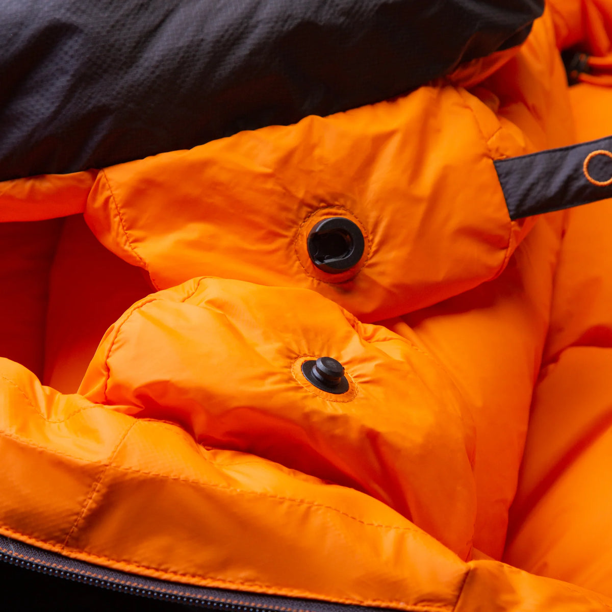 Mountain Equipment Glacier 1000 Sleeping Bag in Obsidian packed into waterproof roll-top stuff sack