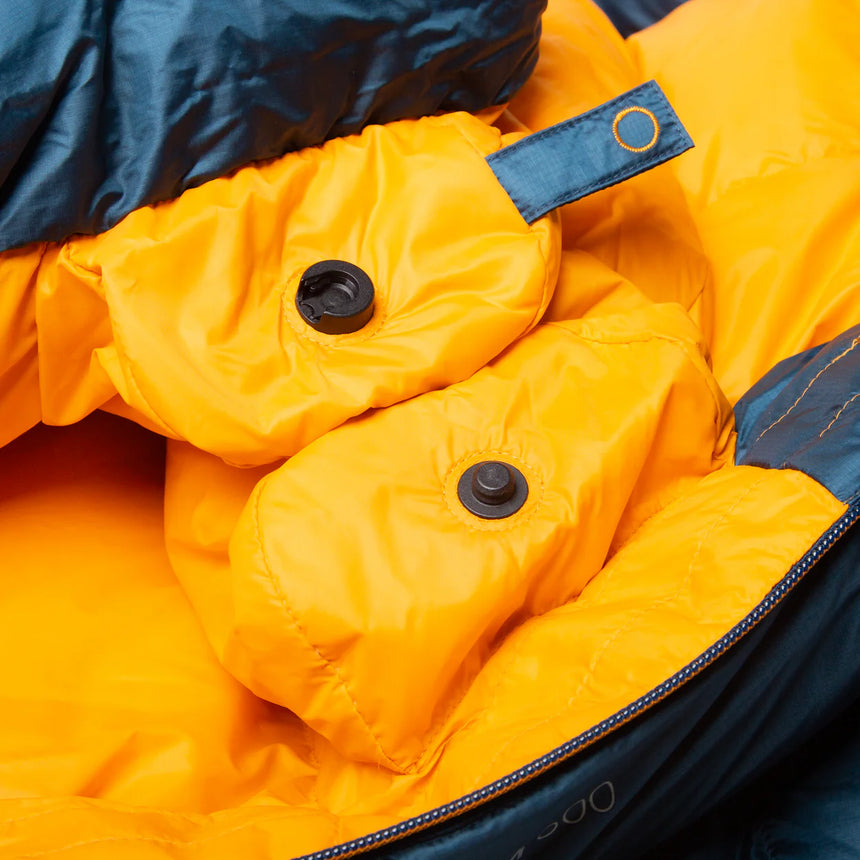 Mountain Equipment Helium 400 Sleeping Bag in Majolica Blue packed into waterproof roll-top stuff sack showing compact 24 x 21 x 20 cm packed size