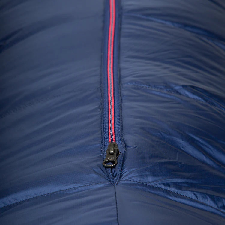 Mountain Equipment Helium 400 Women's Sleeping Bag in Medieval Blue packed into waterproof roll-top stuff sack showing compact 20 x 19 x 22 cm packed size