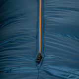 Mountain Equipment Helium 800 Sleeping Bag in Majolica Blue packed into waterproof roll-top stuff sack showing compact 31 x 24 x 24 cm packed size