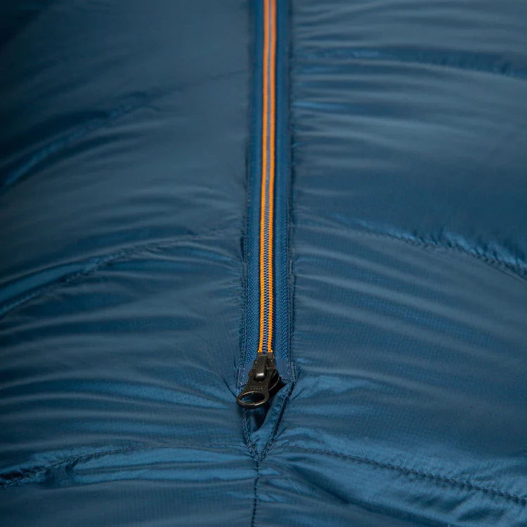 Mountain Equipment Helium 800 Sleeping Bag in Majolica Blue packed into waterproof roll-top stuff sack showing compact 31 x 24 x 24 cm packed size