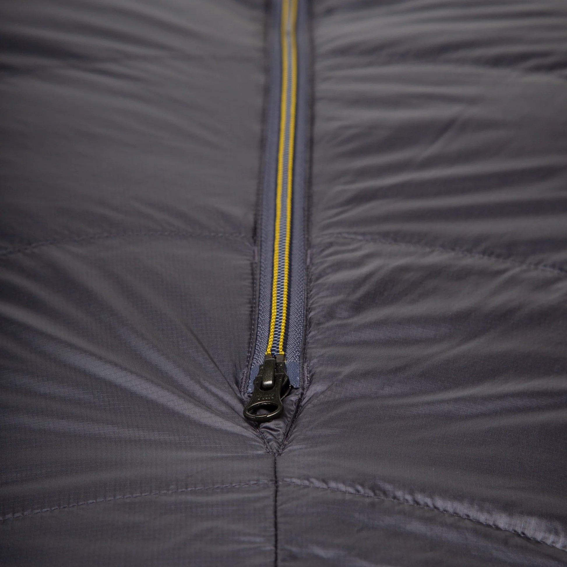 Mountain Equipment Helium GT 800 Sleeping Bag in Anvil Grey - lifestyle view showing warm roomy GT fit sleeping bag for cold-weather trekking and alpine use