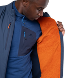 Mountain Equipment Switch Men's Vest in Dusk/Cosmos packed into hand pocket showing lightweight packable construction with twin carabiner carry loops